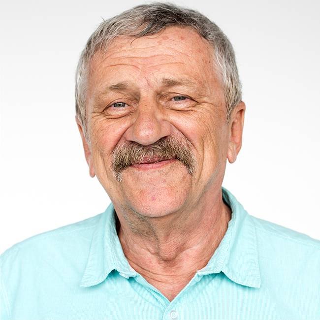 Paradise Medical Maui, Smiling older man with a mustache wearing a light blue shirt.