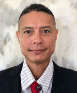 Paradise Medical Maui, Professional man in suit with red tie, confident and composed.