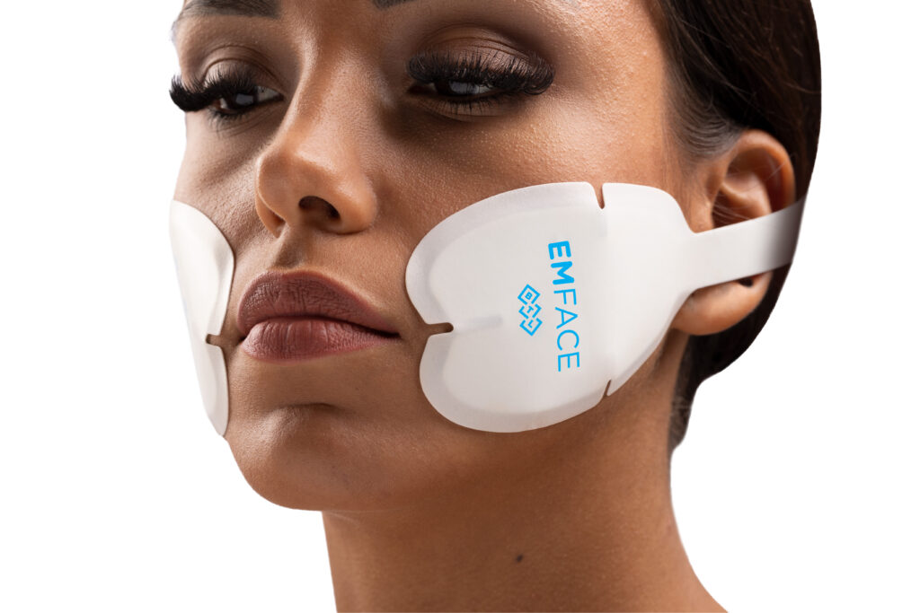 Paradise Medical Maui, Woman with Emface facial rejuvenation treatment pads on face. "EMFACE" text visible.