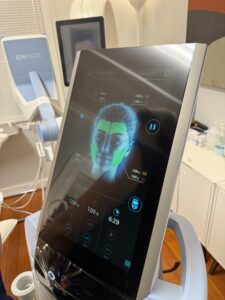 Paradise Medical Maui, EMFACE device screen showing facial therapy areas and settings.