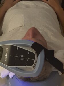 Paradise Medical Maui, TMS treatment: Person undergoing Exomind transcranial magnetic stimulation.