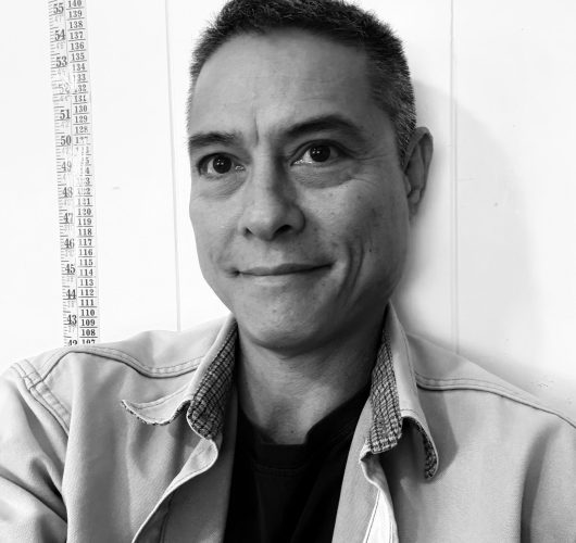 Paradise Medical Maui, Portrait of a man in a casual shirt against a wall with height measurements.