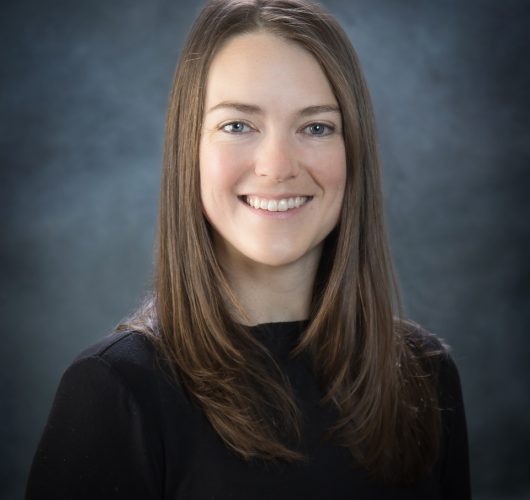 Paradise Medical Maui, Professional headshot of a smiling woman with long brown hair.