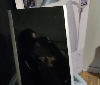 Paradise Medical Maui, Modern aesthetic machine with a reflective surface showing a person's silhouette.