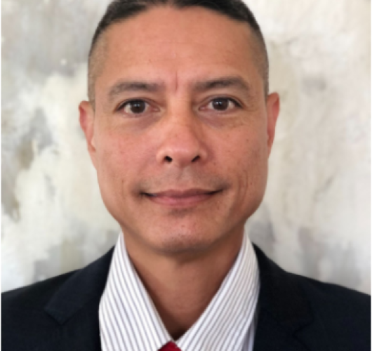 Paradise Medical Maui, Professional man in suit and red tie, promoting health and wellness.