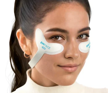 Paradise Medical Maui, Woman with EMFACE patches on her face. "EMFACE" is visible on the patches.